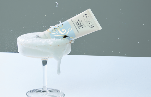 Image of Wonder Balm hair primer in a champagne coupe